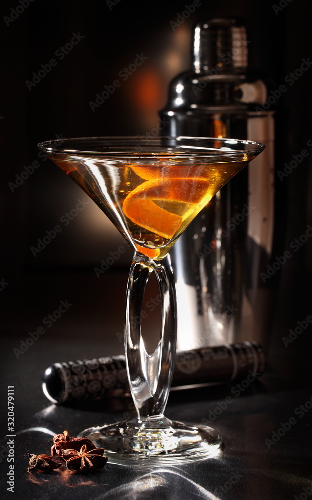 Bright exotic cocktail in a glass on a black background.