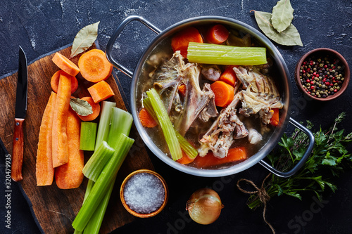 hot chicken stock in a metal stockpot photo