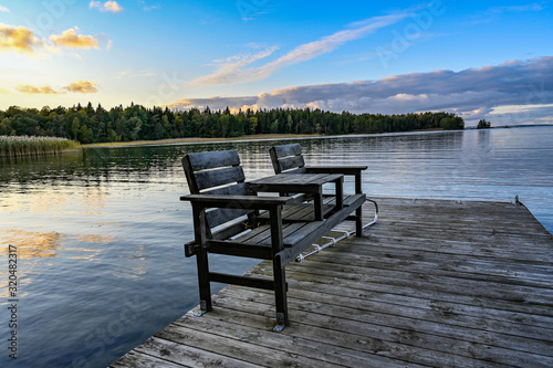 pair of chairs on a wooden jetty in lake Vattern Sweden
