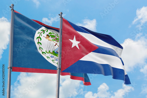 Cuba and Belize flags waving in the wind against white cloudy blue sky together. Diplomacy concept, international relations. photo