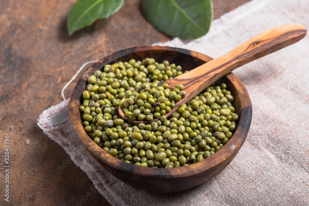 Green mung beans in bowl on wooden background / bean seed cereal whole grains Green mung beans in bowl on wooden background / bean seed cereal whole grains