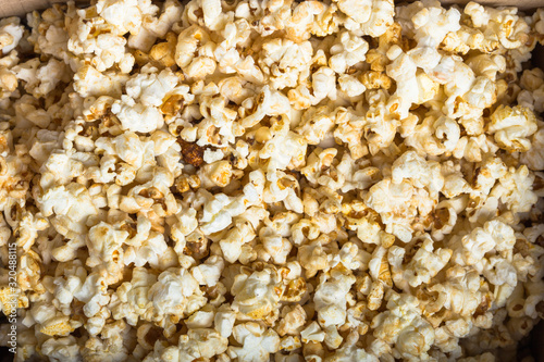 Fresh popcorn textured background. Cinema snack concept. The food for watching a movie and entertainment.