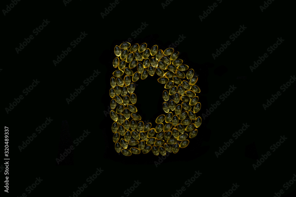 Vitamin d gel capsules on black. Vitamin d gel capsules on black.