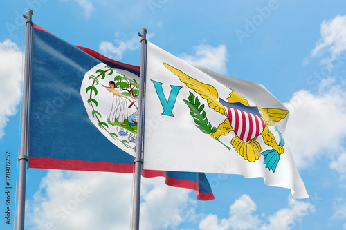 United States Virgin Islands and Belize flags waving in the wind against white cloudy blue sky together. Diplomacy concept  international relations.