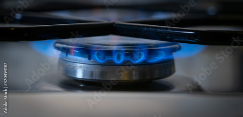 Detail of modern kitchen gas stove with blue flame