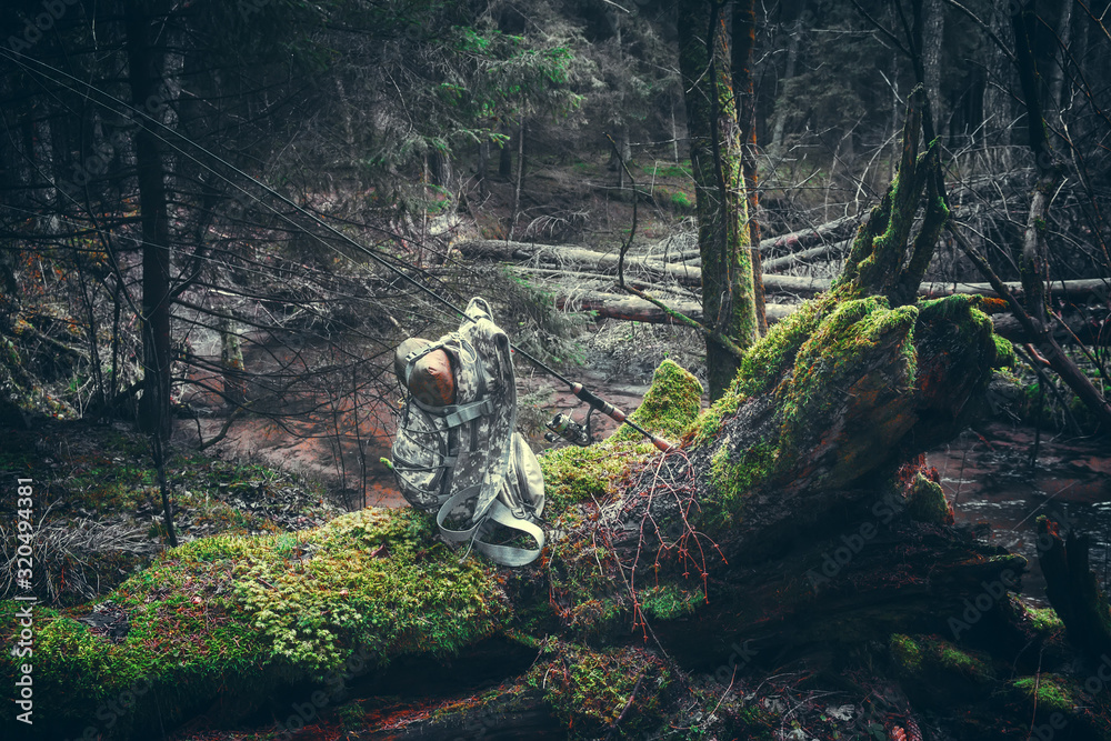 Fishing equipment on a background of forest stream. Fishing equipment on a background of forest stream.