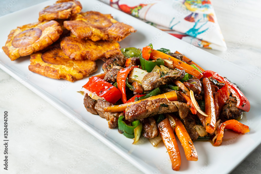 Chopped steak or Bistec Picao and patacones or tostones are fried green plantain slices, made with green plantains, Tipical Panamá food, Panamá, Central America Chopped steak or Bistec Picao and patacones or tostones are fried green plantain slices, made with green plantains, Tipical Panamá food, Panamá, Central America