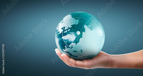 Globe  earth in human hand  holding our planet glowing