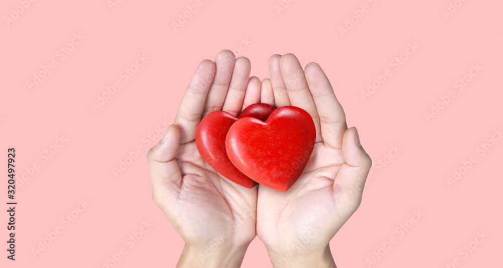 Fototapeta premium Hands holding red heart, heart health, and donation concepts