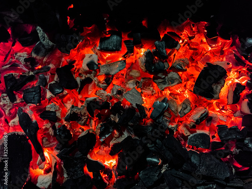 Hot coals from firewood similar to a lava. © Evgeniy Sazhin