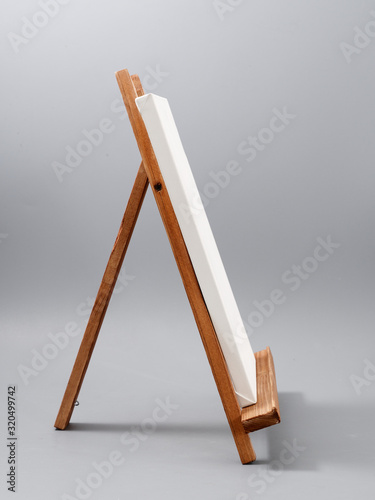 easel made of wood table on a gray background