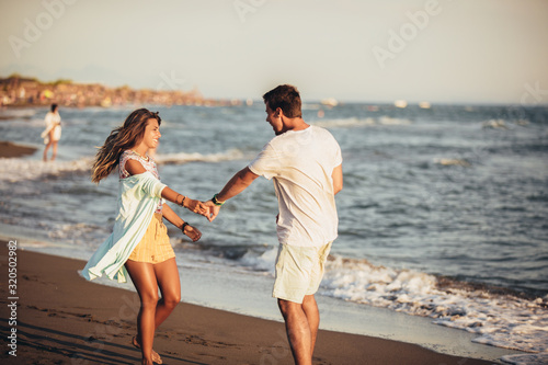 Young couple in love on the beach . Handsome young man with girlfriend on beach.