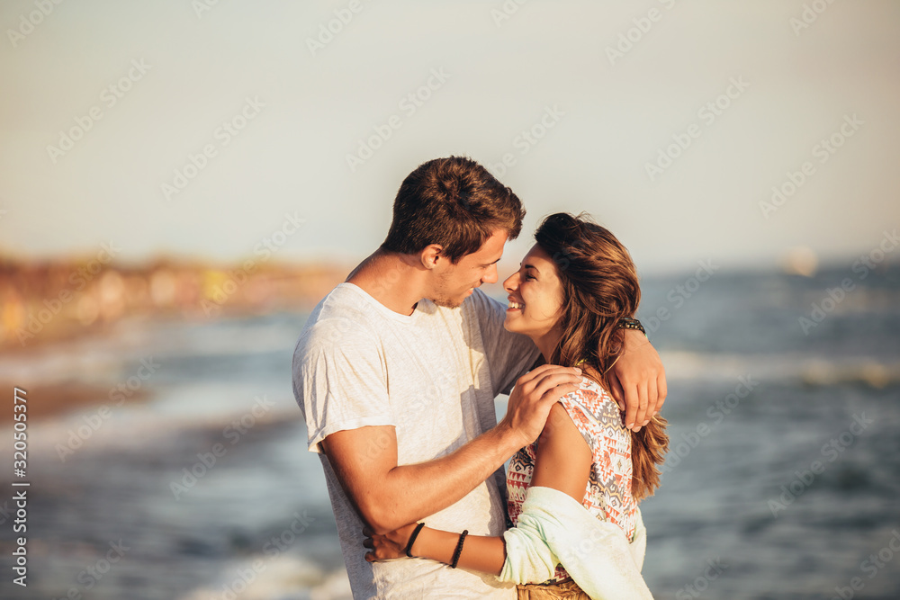 Young couple in love on the beach . Handsome young man with girlfriend on beach. Young couple in love on the beach . Handsome young man with girlfriend on beach.