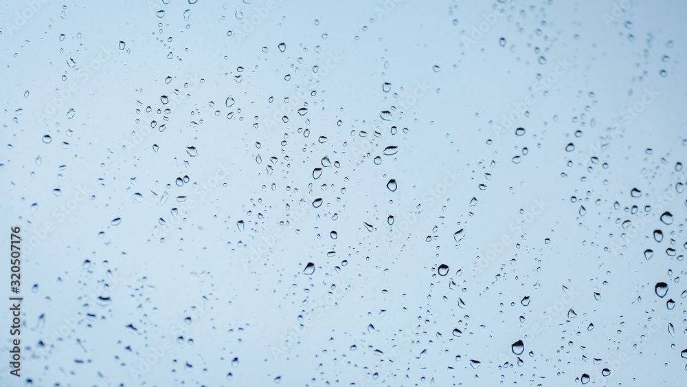Close up of water droplets on glass. Window with rain drops. 