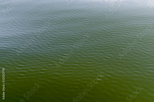 Interesting natural background of water with reflection at artificial Vlasina mountain lake, South eastern Serbia, Europe 