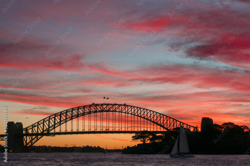 Sydney Harbour Bridge landmark against colorful sunset sky