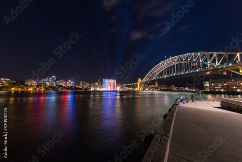 Modern futuristic cityscape with bridge and lights at night © Olga K