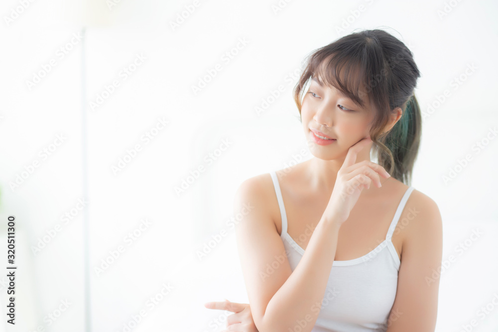 Portrait of beautiful young asian woman smile while wake up healthy and wellness with sunrise at morning in the bedroom, asia girl skin care with happy with fresh, lifestyle and relax concept. Portrait of beautiful young asian woman smile while wake up healthy and wellness with sunrise at morning in the bedroom, asia girl skin care with happy with fresh, lifestyle and relax concept.