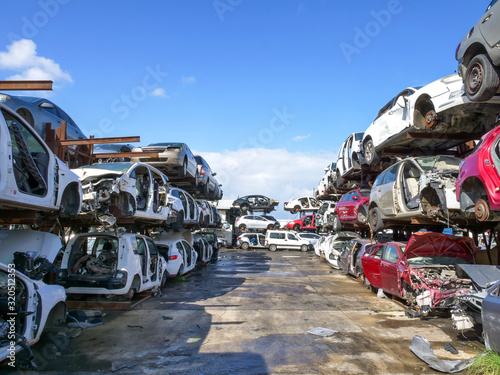 Large Salvage Car parts and Vehicles lot, with rows of stacked totalled Cars photo