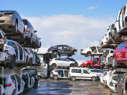 Принти на полотні Large Salvage Car parts and Vehicles lot, with rows of stacked totalled Cars