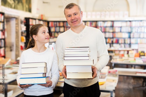 Girl with father holding books