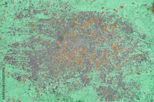 Background of green paint and rusty metal, closeup texture