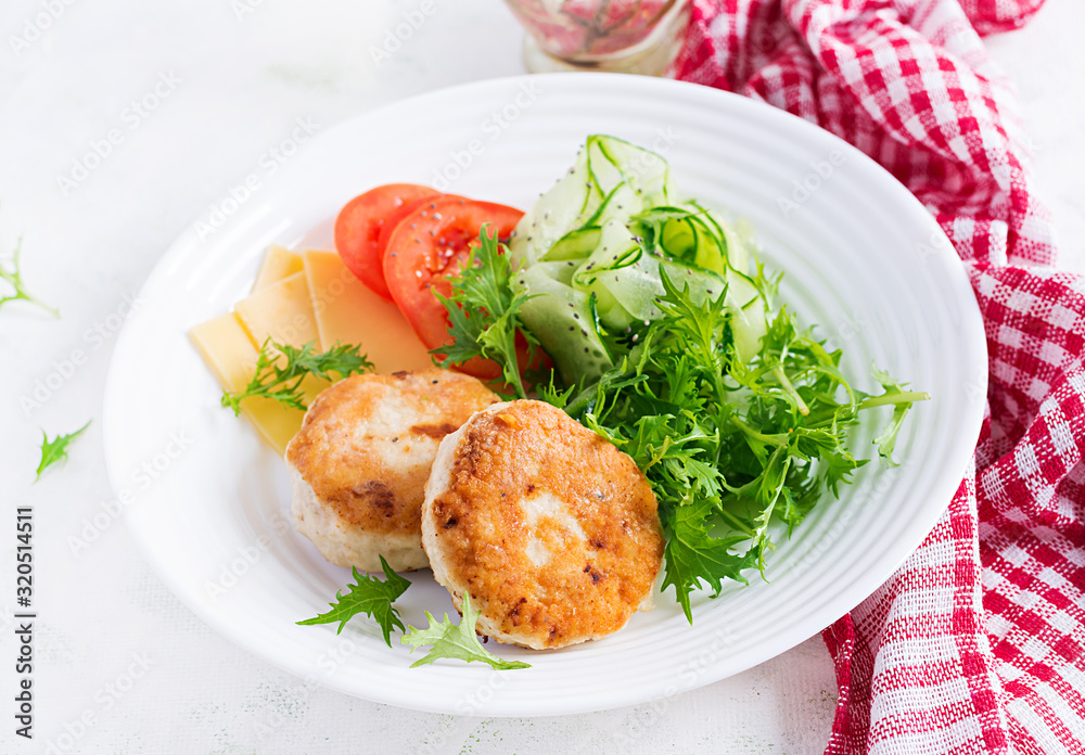 Ketogenic lunch. Chicken burger with tomato, cucumber, cheese and arugula salad without bun. Chicken patties. Healthy food. Keto/paleo diet. Ketogenic lunch. Chicken burger with tomato, cucumber, cheese and arugula salad without bun. Chicken patties. Healthy food. Keto/paleo diet.