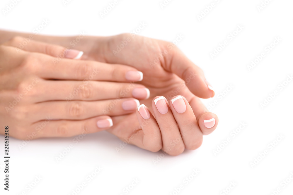 Beautiful woman hands with french manicure on a white background Beautiful woman hands with french manicure on a white background