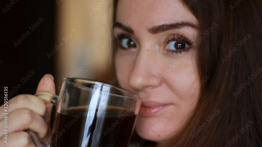 Close up portrait woman with a Cup of coffee. Girl drinking hot aroma drink Close up portrait woman with a Cup of coffee. Girl drinking hot aroma drink