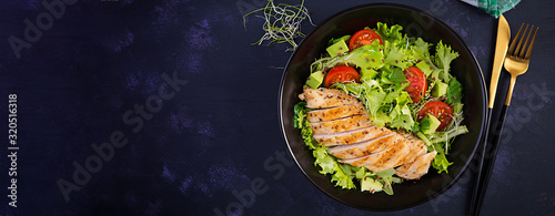 Chicken grilled fillet with salad fresh tomatoes and avocado. Healthy food, ketogenic diet, diet lunch concept. Keto/Paleo diet menu. Top view, banner