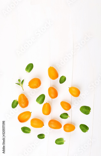 Organic kumquats on white background.