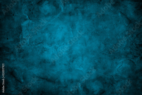 Grunge dark blue painted wall texture background.