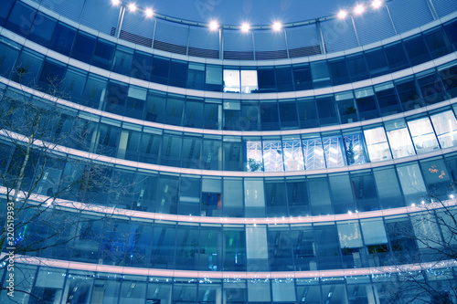 Night architecture - building with glass facade. Abstract image of office building