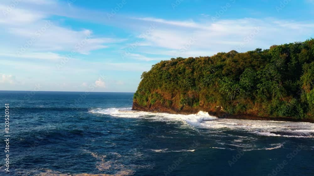 Cliff and wild coastline of the tropical rain forest in French Polynesia, shot in aerial view, flying over blue ocean water, lush green jungle, travel, landscape and nature concept Cliff and wild coastline of the tropical rain forest in French Polynesia, shot in aerial view, flying over blue ocean water, lush green jungle, travel, landscape and nature concept
