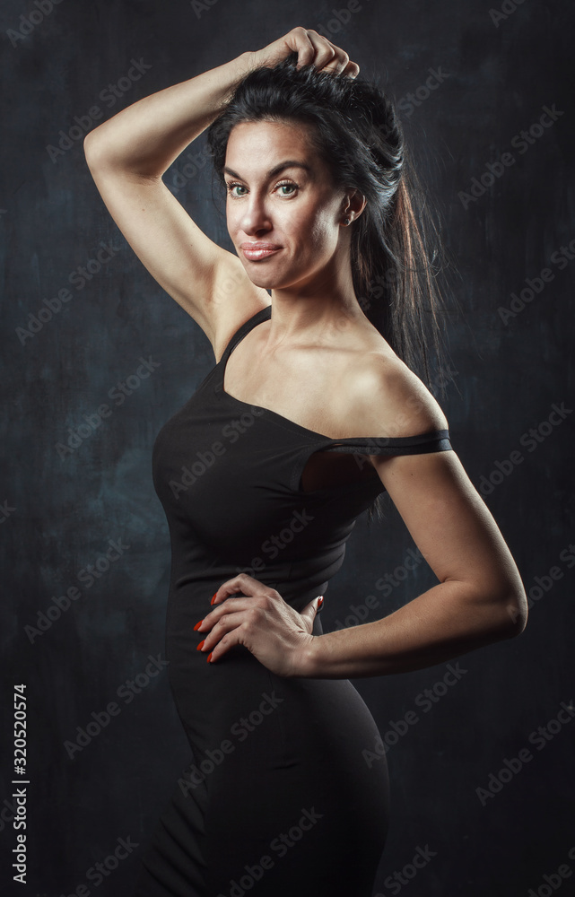 portrait of a burning brunette on a dark background portrait of a burning brunette on a dark background