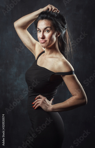 portrait of a burning brunette on a dark background © viktoriya85