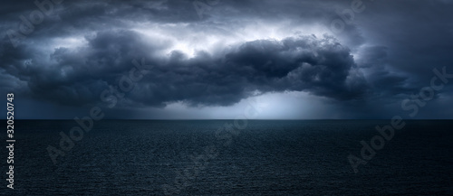 Canvas Print dark and dramatic stormy clouds over sea