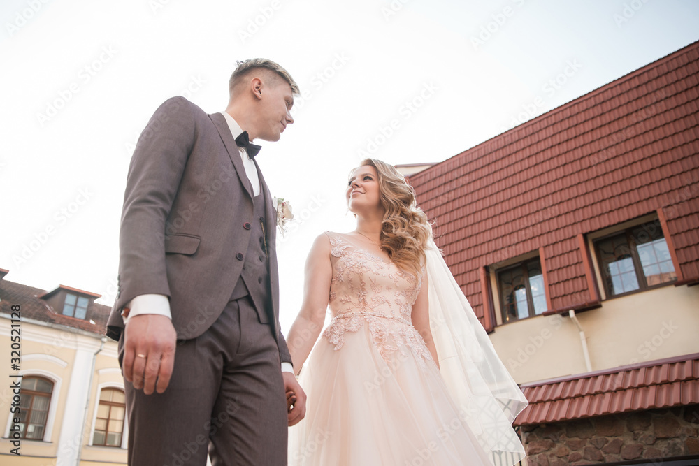 Fototapeta premium bride and groom walking down the street of the old town.