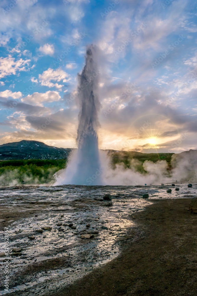 A vertical shot of Strokkur Geysir, a famous hot spring in southwestern Iceland.