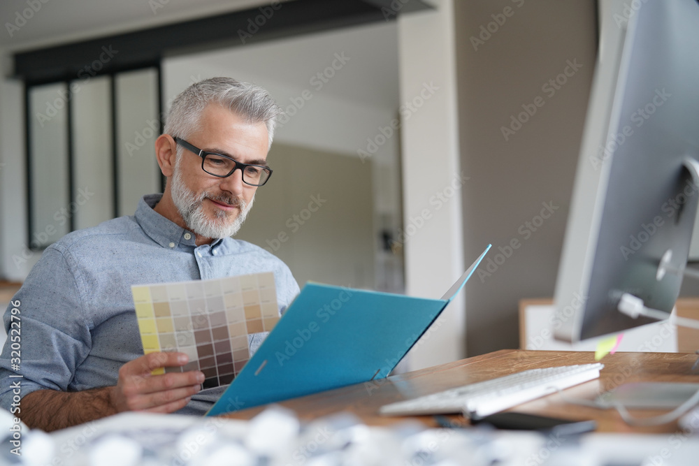 Home designer working in office on desktop Home designer working in office on desktop