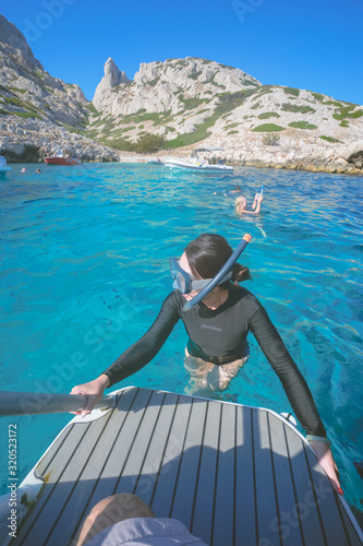 Marseille, France - August 13th, 2019:People are swimming and diving in Calanques de Morgiou, Marseilles, Provence, South of France.  Everyone looks very cheerful and happy.
