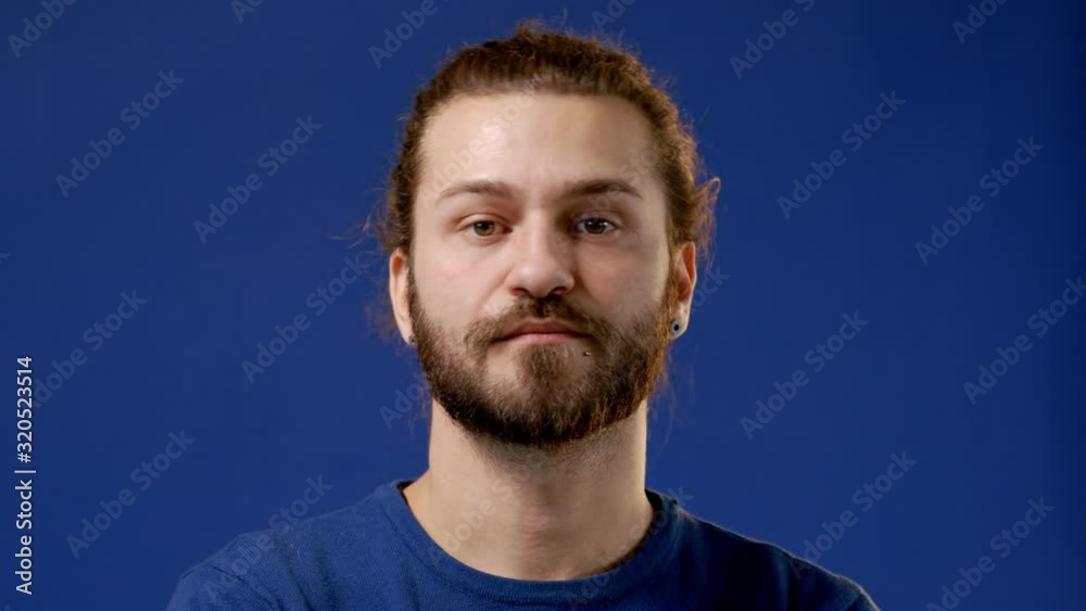 Young attractive bearded hipster smiling, laughing and looking at camera. 