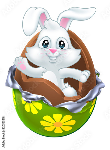 The Easter bunny rabbit breaking out of a chocolate egg