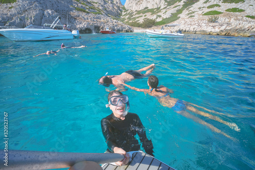 Marseille, France - August 13th, 2019:People are swimming and diving in Calanques de Morgiou, Marseilles, Provence, South of France. Everyone looks very cheerful and happy.