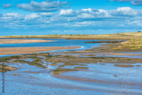 Canvastavla Views of mudflats at low tide from Norfolk Coast path National Trail near Burnham Overy Staithe, Scolt Head Island to rear, East Anglia, England, UK