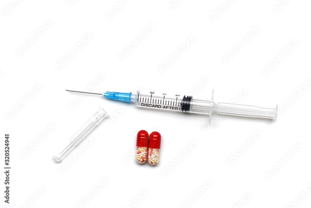syringe with injection and two capsules on a white background. syringe with injection and two capsules on a white background.