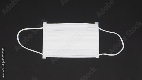 N95 Mask help to protect dust and  corona virus or other particle, put on black background. photo
