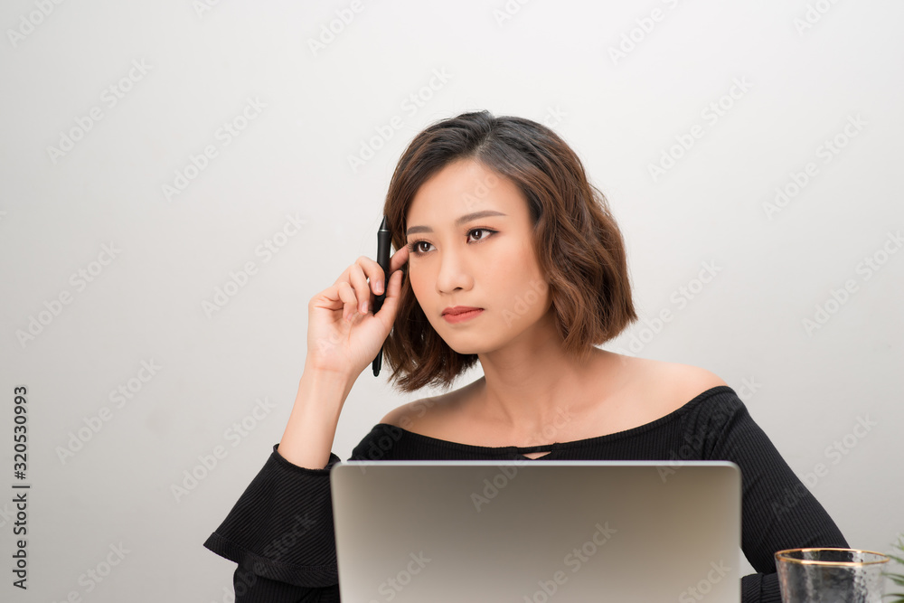 Asian girl graphic designer thinking idea for a new project, freelancer thinking idea for a new project in selective focus. Asian girl graphic designer thinking idea for a new project, freelancer thinking idea for a new project in selective focus.