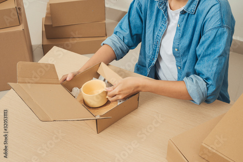 Young startup entrepreneur small business owner working at home, packaging and delivery situation.