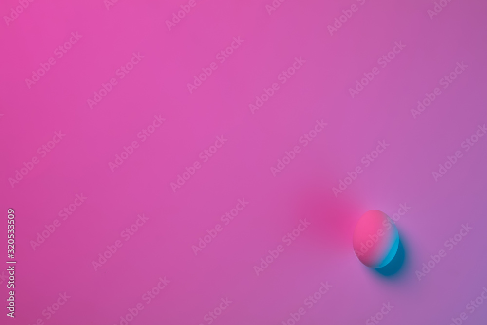 Egg hunt is coming. Easter traditions, pink-blue colored eggs on pink background, neon light, top view, copyspace for ad. Concept of holidays, spring, celebrating, food and sweets, family time.